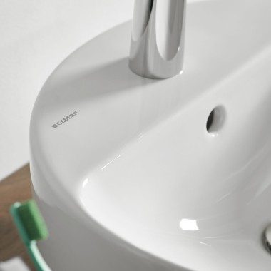 Close up on Variform tap bench with Geberit Logo on ceramic Close up on Variform tap bench with Geberit Logo on ceramic