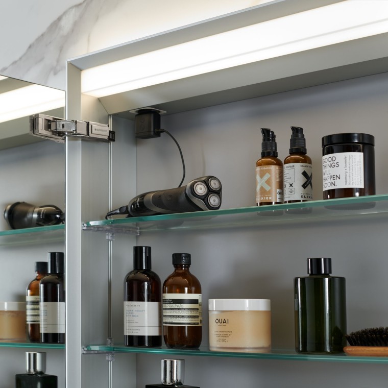 Open Geberit mirror cabinet in which bathroom items are stored Open Geberit mirror cabinet in which bathroom items are stored