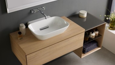 Salle de bains avec des meubles en bois de la série Geberit Acanto