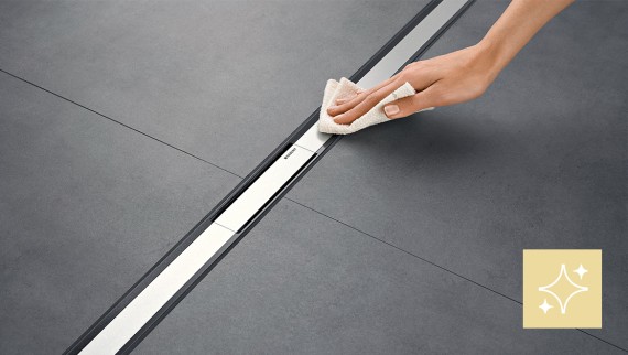 Woman cleaning the Geberit CleanLine shower channel