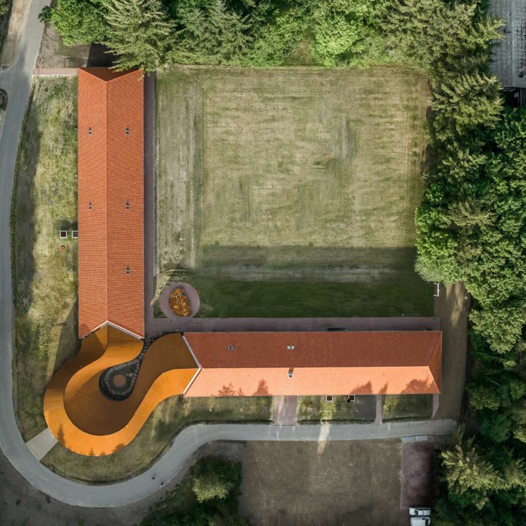 La vue plongeante montre le nouveau bâtiment circulaire qui relie les deux ailes historiques aux toits en tuiles (© R_Hjortshoj) La vue plongeante montre le nouveau bâtiment circulaire qui relie les deux ailes historiques aux toits en tuiles (© R_Hjortshoj)